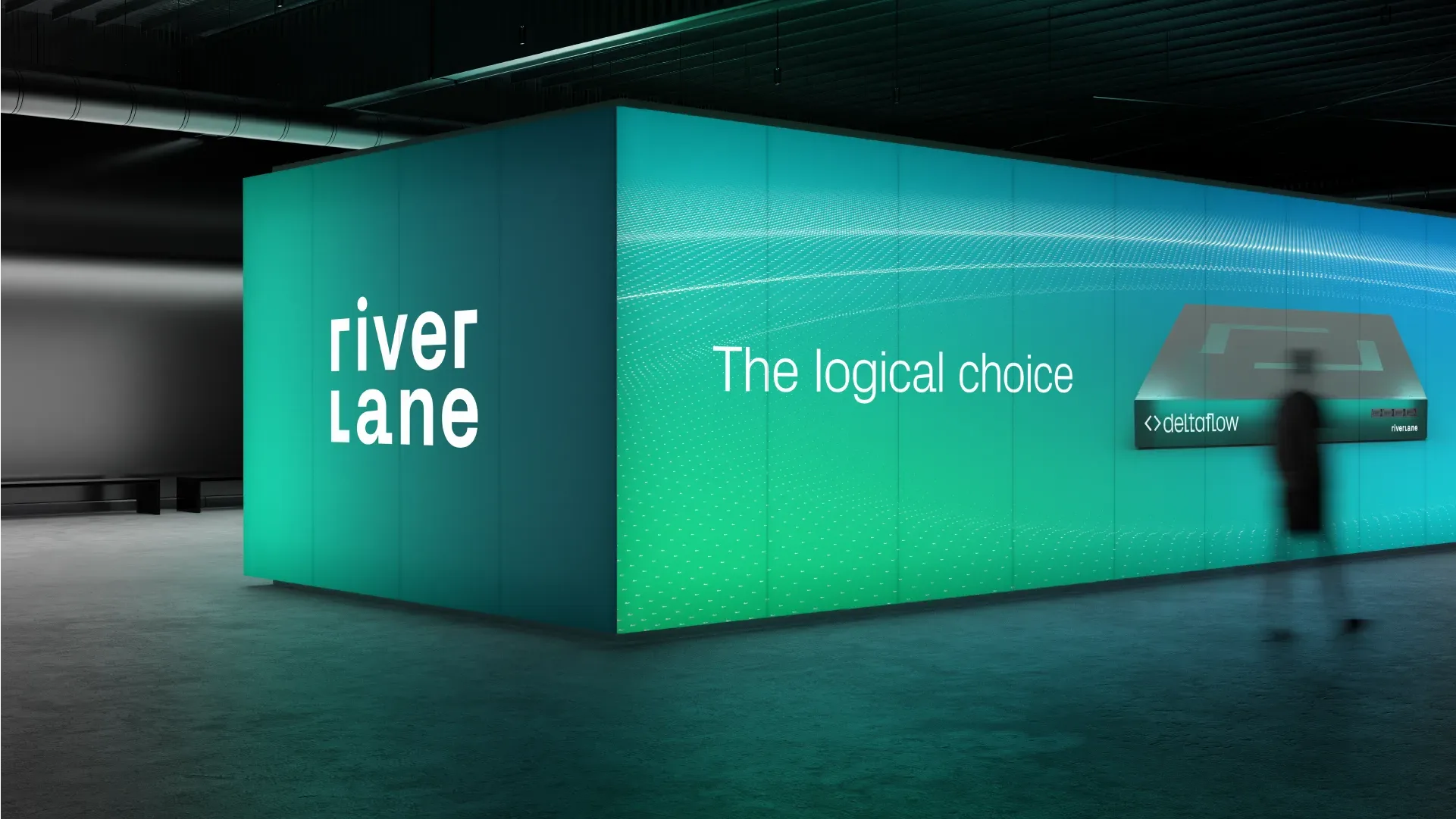 Large illuminated exhibition booth with Riverlane branding, the phrase ‘The logical choice,’ and a Deltaflow product display in a dark venue.