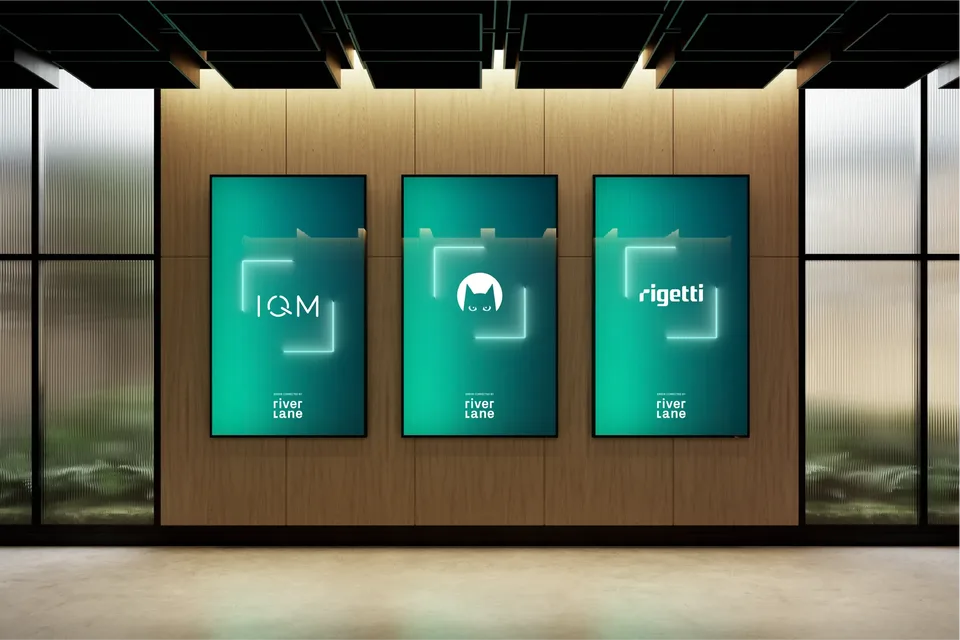 Three illuminated posters on a wood-panel wall displaying IQM, Alice + Bob, and Rigetti logos, representing quantum computing partners.