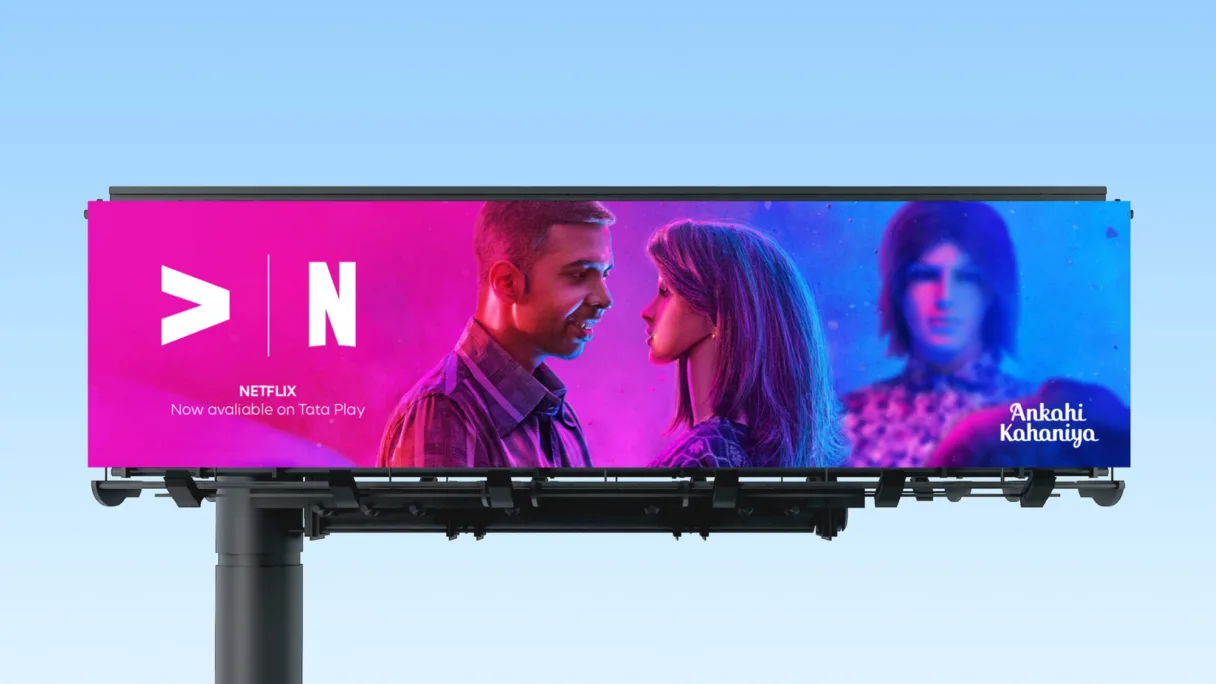Image of a billboard featuring Ankahi Kahaniya content, advertising that Netflix is now available through Tata Play, set against a blue sky.