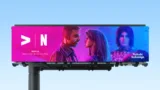 Image of a billboard featuring Ankahi Kahaniya content, advertising that Netflix is now available through Tata Play, set against a blue sky.